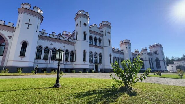 The Puslovsky Palace in Belarus. The Kossovsky Autumn Castle. An old historical castle in Kosovki in sunny weather in autumn. An architectural monument in the style of English Neo-Gothic. 4K