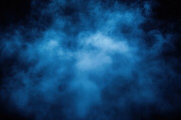 Dense blue smoke or fog swirling against a dark black background creating a mysterious and ethereal atmosphere