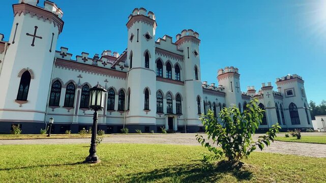 Belarus, Puslovsky Palace, September 5, 2024: Kossovsky Autumn Castle. An old historical castle in Kosovki in sunny autumn weather. An architectural monument in the style of English Neo-Gothic. 4K