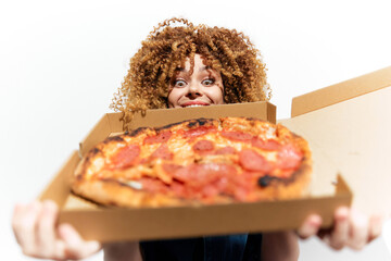 Happy woman holding a delicious pepperoni pizza in a takeaway box, showcasing excitement and joy, against a bright white background