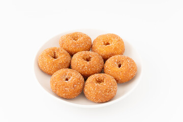 白背景にお皿に盛りつけた美味しそうなミニドーナツ