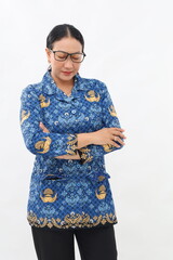 Happy civil servant with uniform standing folded arms while looking down