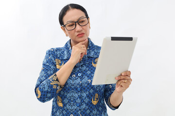 Portrait of asian civil servant woman looking at digital tablet with thinking gesture, side view....