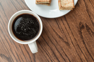 Morning Bliss, Fresh Black Coffee with Crispy Toast on Wooden Table. Copy space.