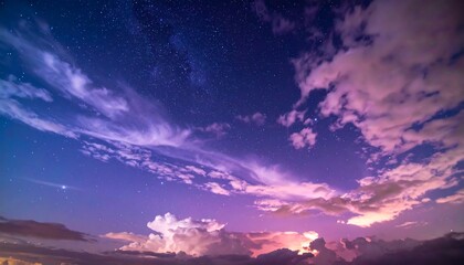 Obraz premium Celestial Canvas: A Night Sky Symphony of Stars and Clouds