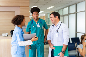 Team of diversity doctor and nurse is discussing and brainstorming over patient medical record after diagnosis for precise care plan with experienced senior physician specialist