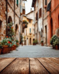 Rustic wooden table overlooking blurred Italian street scene with colorful buildings and flower pots in Tuscany Italy