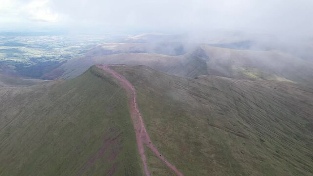 Breath taking shot of Pen y Fan mountain from height. Mountain landscape scenery from bottom cloud layer. Brecon Beacons national Park, Wales, UK