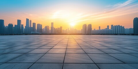 Empty concrete plaza with modern city skyline in the background at sunset
