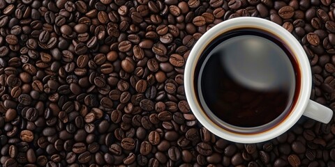 Fototapeta premium A cup of coffee with a white background and coffee beans surrounding it.