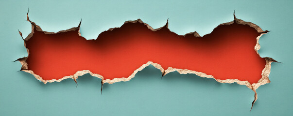 A large hole in a wall with a red background. The hole is large enough to see through