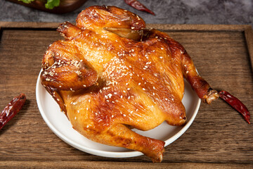 A whole delicious roasted chicken on table.