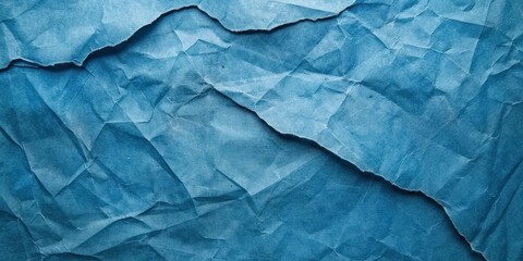 Obraz premium A blue, crumpled paper texture with a blue background.