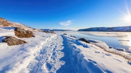 Winter snowscape path toward lake scenic landscape on sunny day