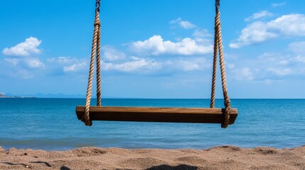 Swing Hangs Over Sandy Beach with Ocean View Under Blue Sky and Fluffy White Clouds