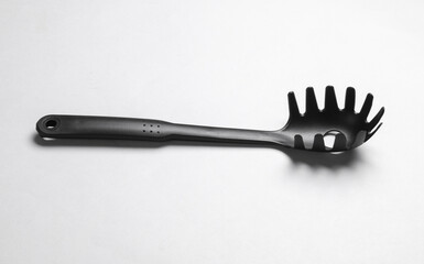 Black plastic kitchen tool on white background