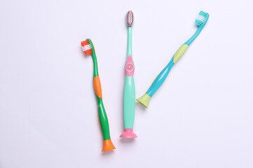 Children's plastic toothbrushes on a white background