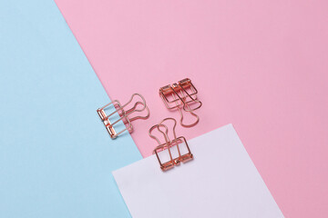 Memo white square sheet of paper with binder clips on pastel background. Stationery, education,...