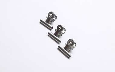 Metallic binders clips on white background