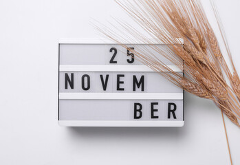 25 november letterboard text on Lightbox with dry lagurus flowers, white background. Seasonal calendar. Flat lay. Top view