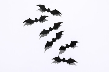 Halloween decoration concept. Black paper bats flying on white background. Top view