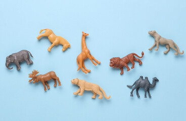 Children's zoo set of plastic wild animals on blue background