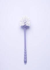 Toilet brush on a pastel background. Top view
