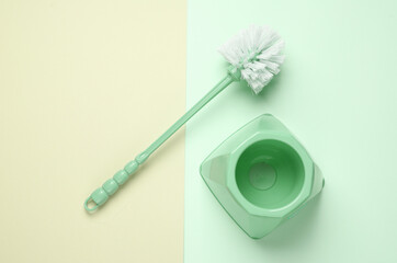 Toilet brush on a pastel background. Top view