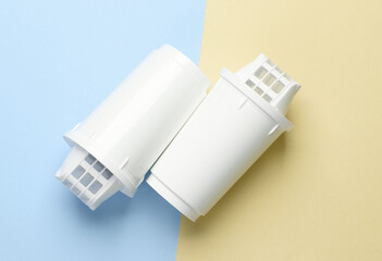 Cartridge filters for water filtration on pastel background. Top view