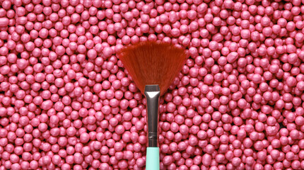 Makeup brush on pink make up powder balls. Beauty concept