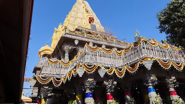 holy hindu temple architecture with bright blue sky at day