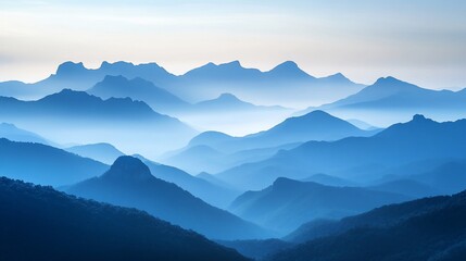 Obraz premium Ethereal Blue Mountainscape with Layers of Peaks and Mystical Fog