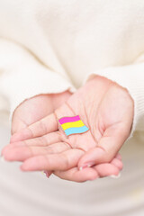 Pansexual Visibility Day and Panromantic May Awareness Day and LGBT pride month concept. hand holding pink, yellow and blue heart shape for Lesbian, Gay, Bisexual, Transgender and Marriage Equality