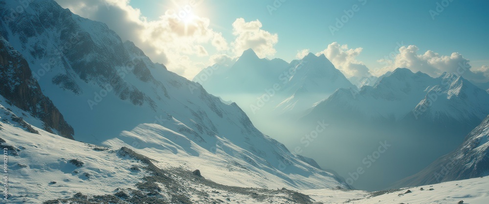 Poster Majestic snow-covered mountain range with the sun shining through the clouds, creating a serene and expansive landscape