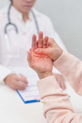 Senior woman having Tremor hand and consulting doctor in hospital. Parkinson disease April awareness month, Carpal Tunnel Syndrome, rheumatoid and brain injury and Neurological disorder concept