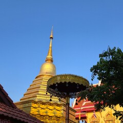 Naklejka premium North of Thailand golden pagoda in temple with Buddha. Beautiful archaeological site