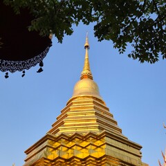 Fototapeta premium North of Thailand golden pagoda in temple with Buddha. Beautiful archaeological site