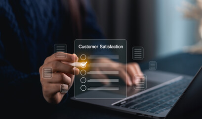 Close-up businesswoman hand interacting with virtual customer satisfaction survey on laptop, demonstrating technology, engagement, and user experience in modern workspace