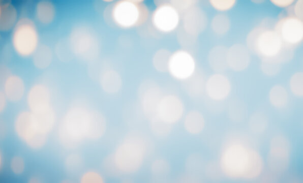 Blurred light bokeh on blue background creating a soft dreamy festive atmosphere.
