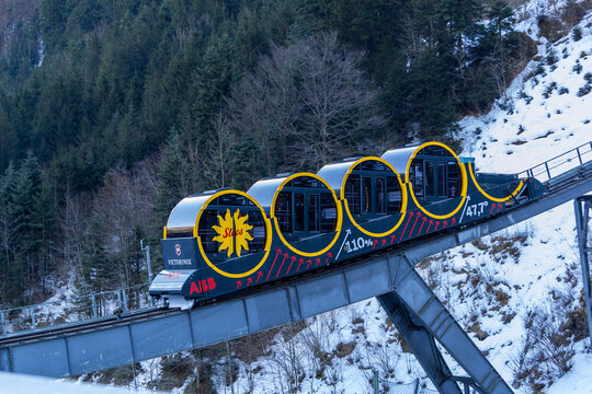 Stoos, Switzerland - 09 February 2022:  the unique and innovative funicular rail to Stoos in Switzerland. It is the steepest funicular in the world. It reaches maximum gradient of 110 percent.