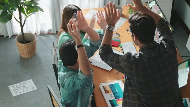 Close up of smart business team hands looking at color palette at table while throw paper in the air. Group of interior design talking and discussing about successful idea and celebrating. Symposium.