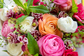 Spring mixed bouquet. Beautiful pastel colored fresh flowers arrangement. Birthday bouquet made of ranunculus photographed outdoors.