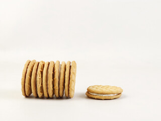 Minimalist composition of a stack round sandwich cookies displayed on a white background.