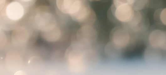 Abstract blurred background with bokeh lights in beige and blue tones.