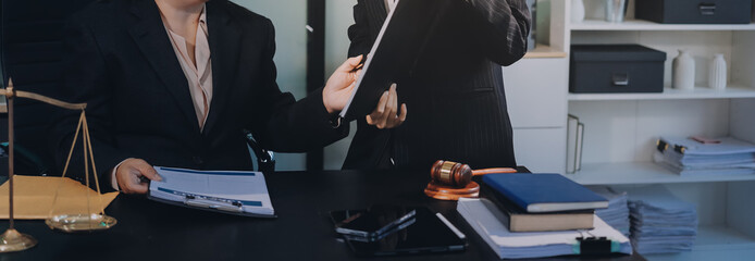 Obraz premium Judge gavel with Justice lawyers, Business woam in suit or lawyer working on a documents. Legal law, advice and justice concept..