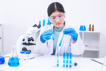 Fototapeta premium Scientist girl in lab coat observing chemical substance with care during experiment. Science, laboratory, scientist, experiment, and research represent discipline and education, healthcare.