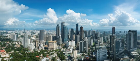 Naklejka premium Aerial view showcases a vibrant cityscape under expansive cloudy sky