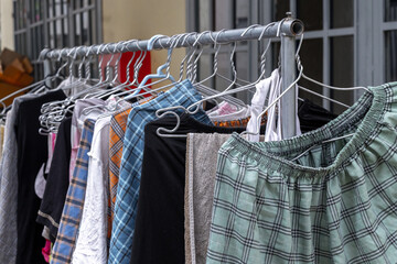 Colorful assortment of clothing hanging on a metal rack