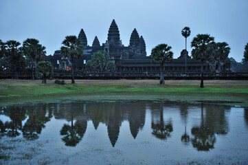 Stunning view of ancient Angkor Wat Temple reflection in the pond water . 