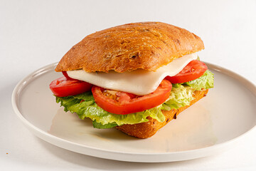 A delicious sandwich showcasing layers of lettuce, tomato, and creamy cheese on freshly baked bread